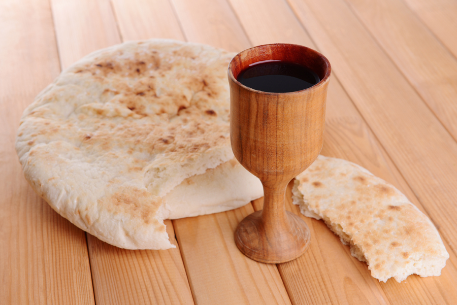 Cup of wine and bread on table close-up