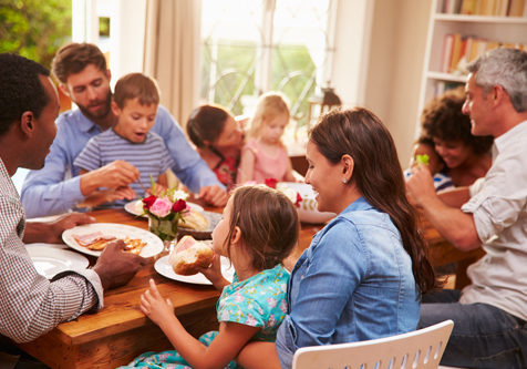 Family and friends sitting at a dining table